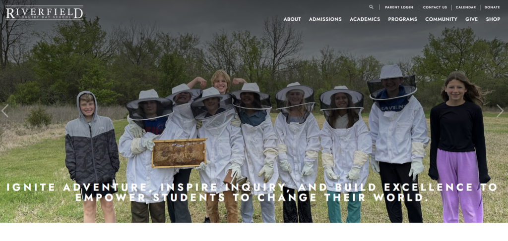 Young students dressed as beekeepers while holding a honeycomb